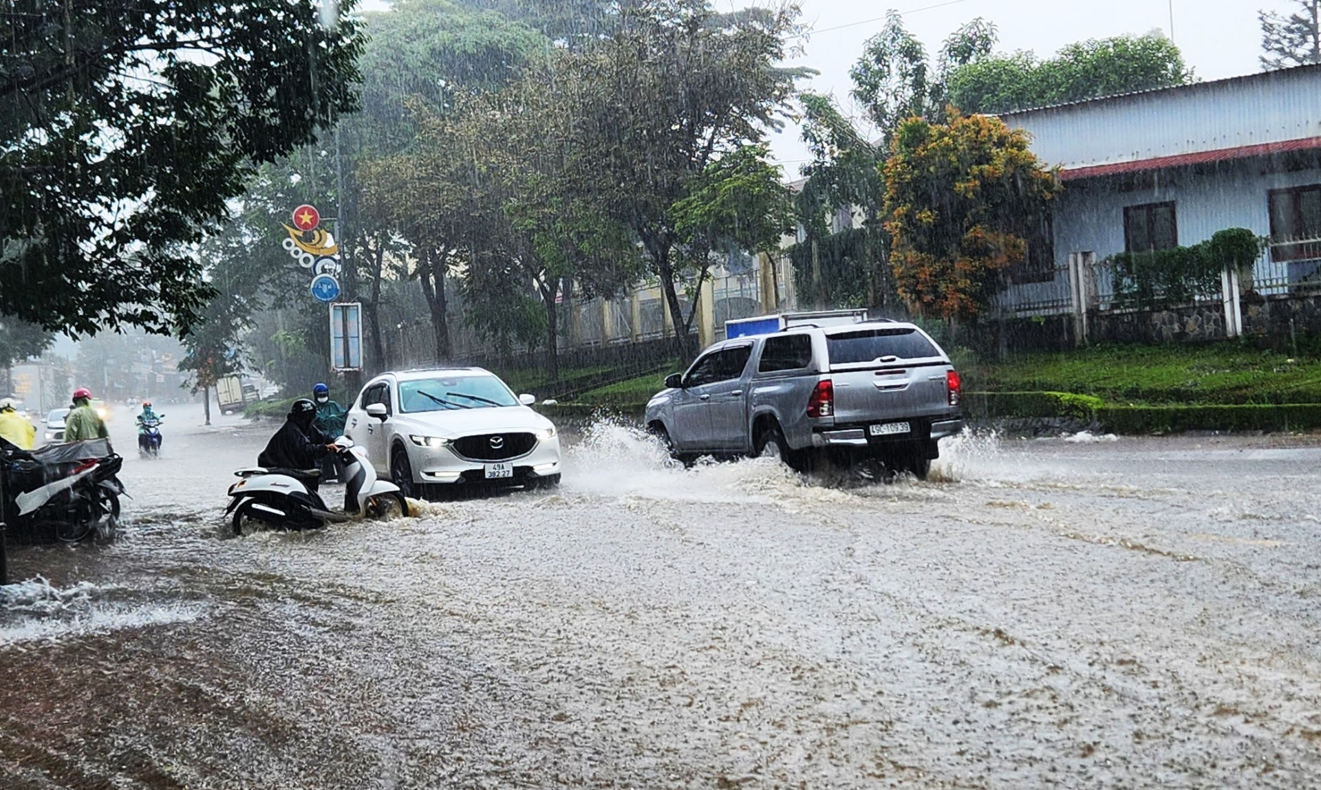 Người điều khiển xe máy qua tuyến đường bị ngập khiến xe chết máy