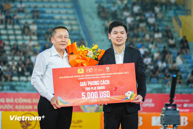 Ông Đỗ Vinh Quang (phải), Phó Chủ tịch Tập đoàn T&T Group, đại diện nhà tài trợ trao Giải Phong cách cho Đội Công an Lào. (Ảnh: Việt Anh/Vietnam+) vnp-phochutich.jpg