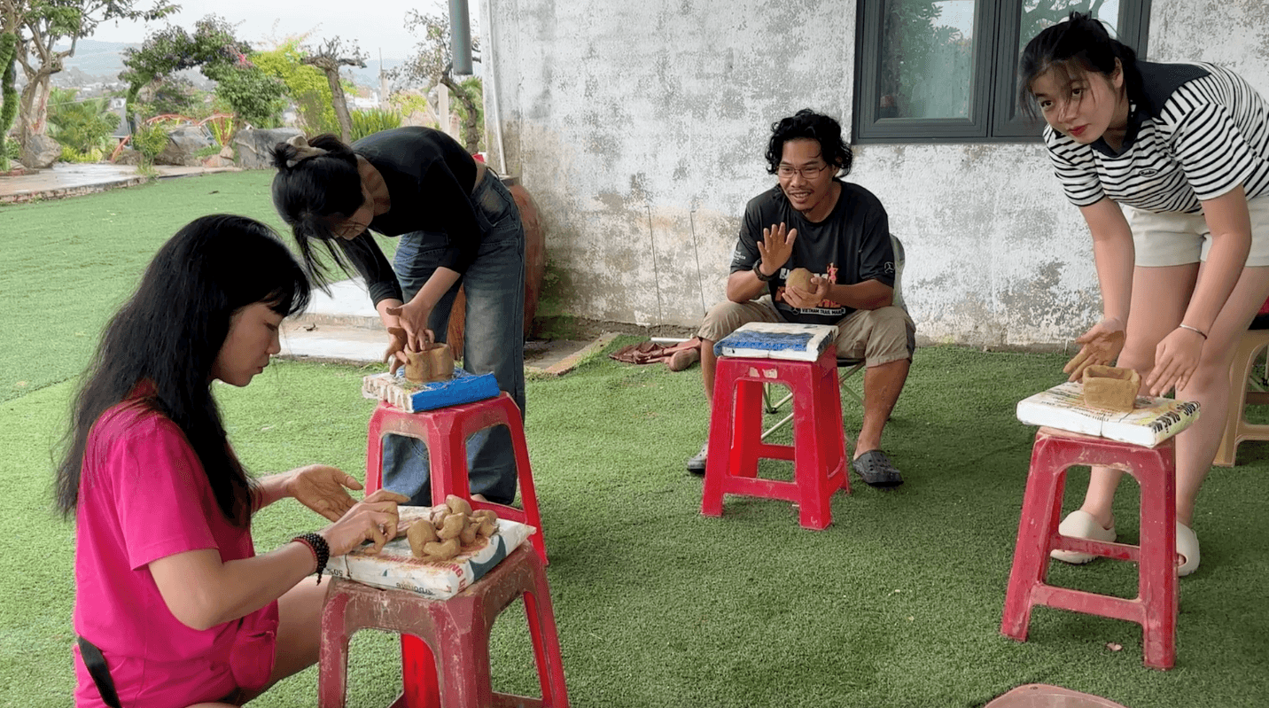Tourists excitedly learning Churu pottery-making under local guidance