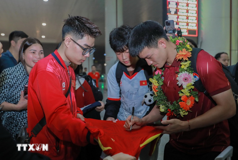 Cầu thủ đội tuyển bóng đá nam U22 Việt Nam ký tặng người hâm mộ. (Ảnh: Phan Phương/TTXVN)