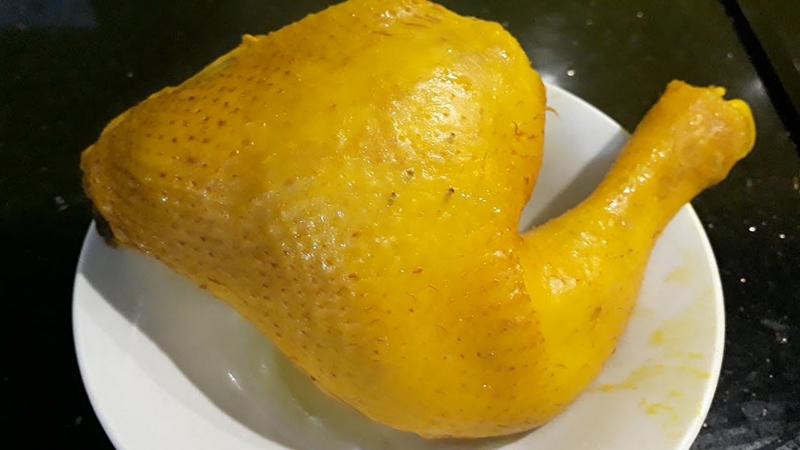 Công đoạn luộc gà với bột nghệ giúp thịt có màu sắc hấp dẫn