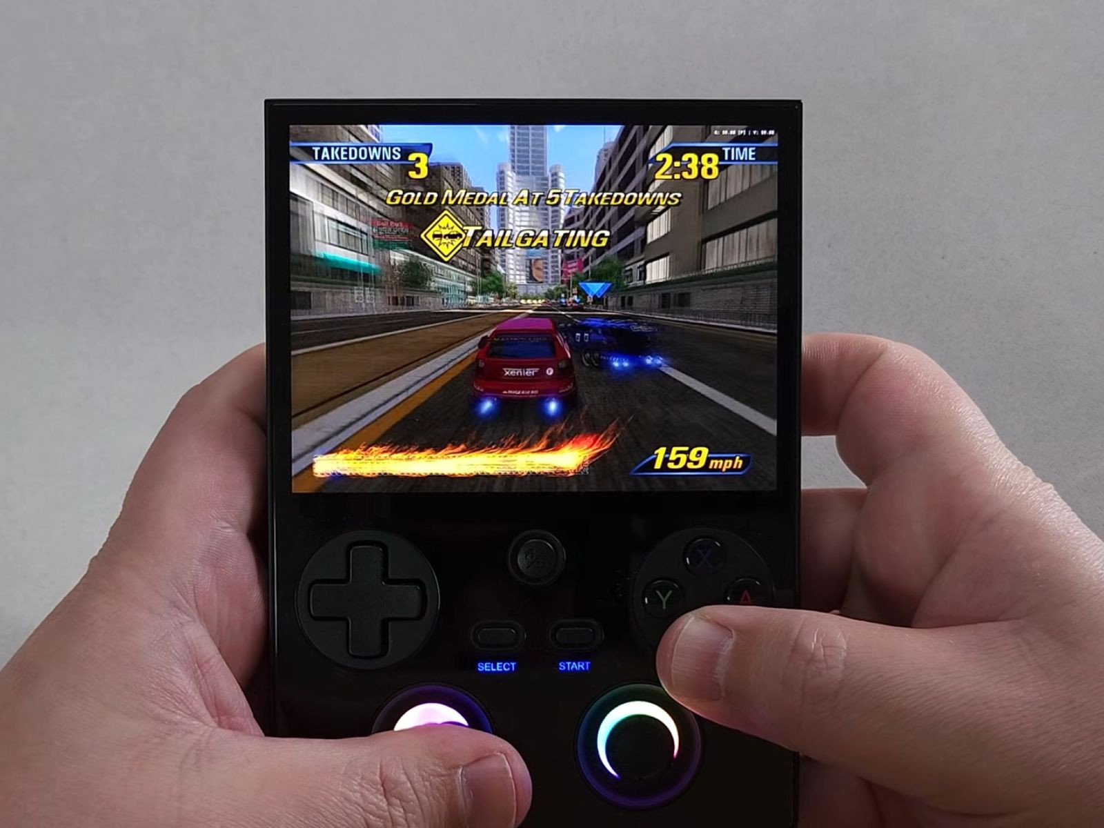 Anbernic RG477V handheld running a racing game during gameplay