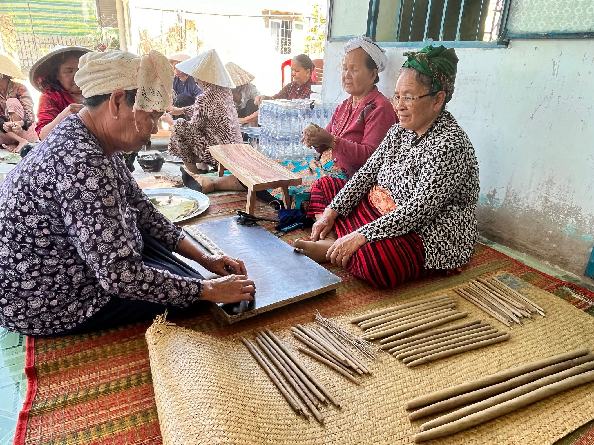 Bà con lối xóm đến chung vui, cùng nhau làm nến, cắt vải và thực hiện các phong tục của người Chăm.