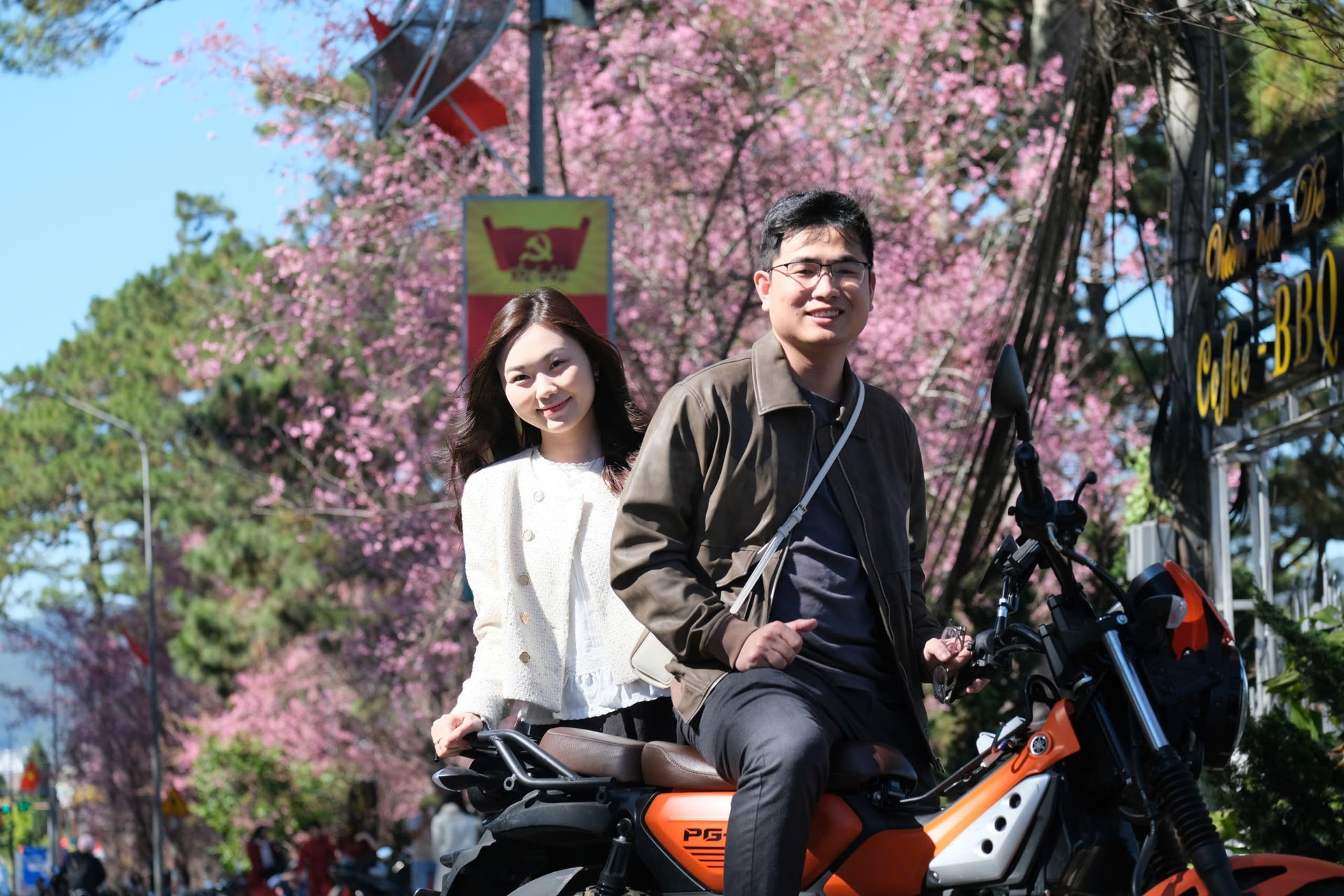 Young people capture moments of youth amid the vivid pink cherry blossoms