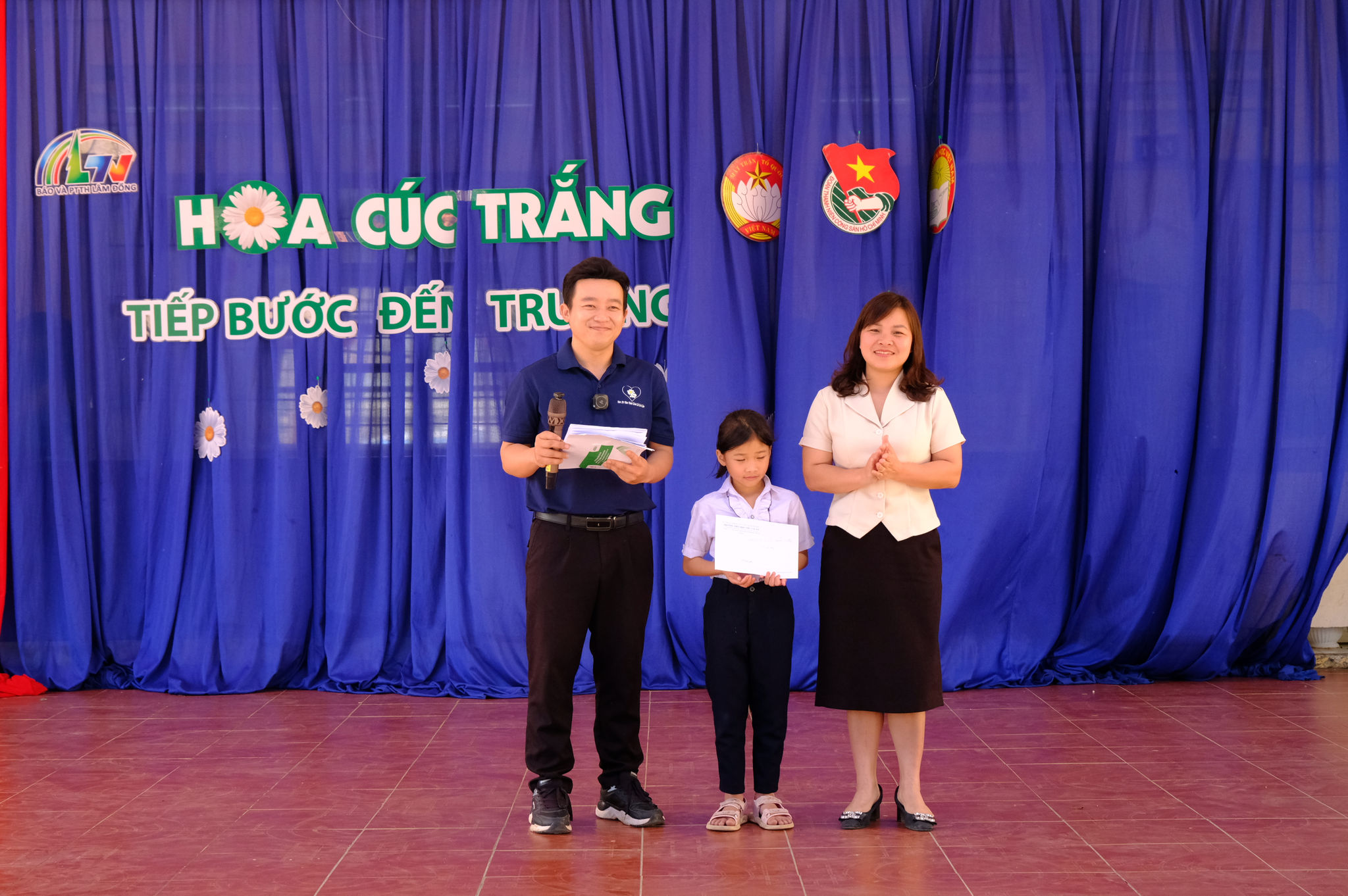 Bà Nguyễn Thị Nhung - Chủ tịch Ủy ban MTTQ Việt Nam xã Đam Rông 1 trao học bổng cho Anh Thư