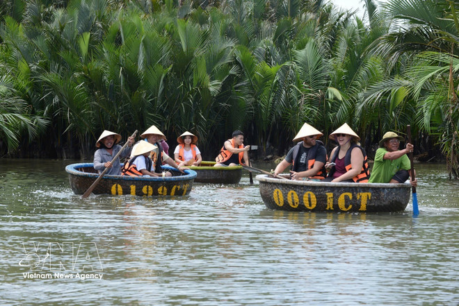 Tourists visit the Bay Mau coconut forest in Da Nang city. (Photo: VNA) vnanet-tourism2.jpg