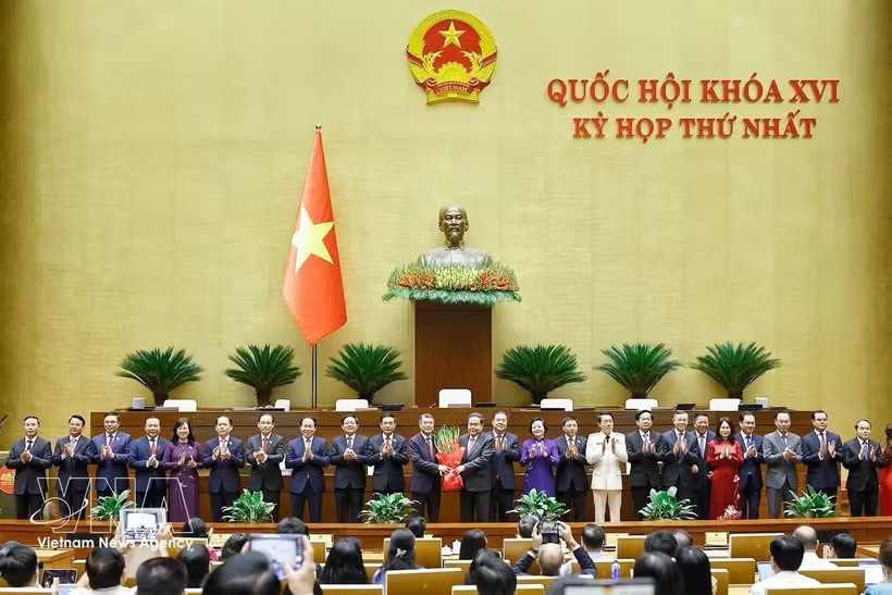 NA Chairman Tran Thanh Man presents flowers to congratule the Prime Minister, Deputy Prime Ministers, Ministers and Government members. (Photo: VNA)