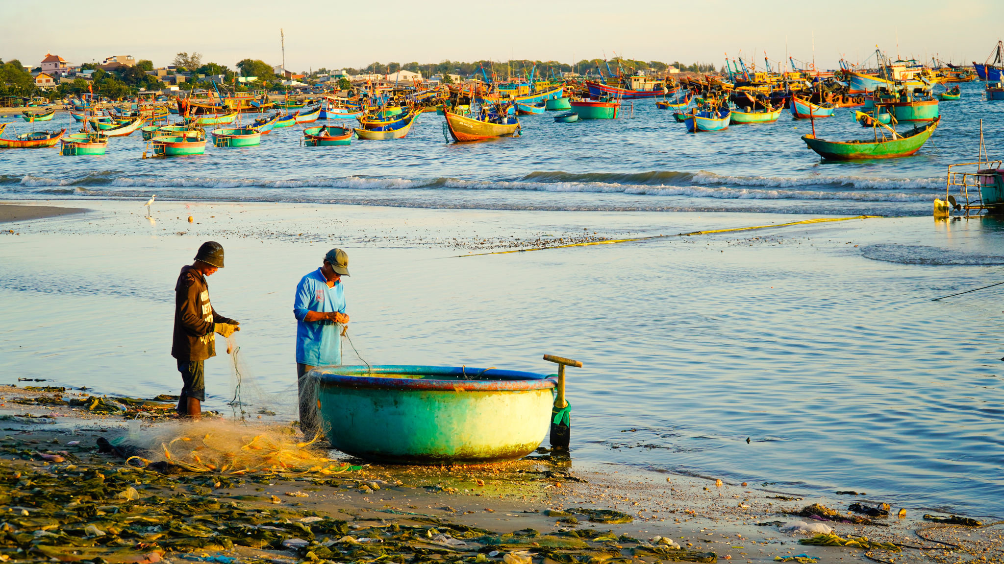 Fishermen prepare crab nets for the next fishing trip.
