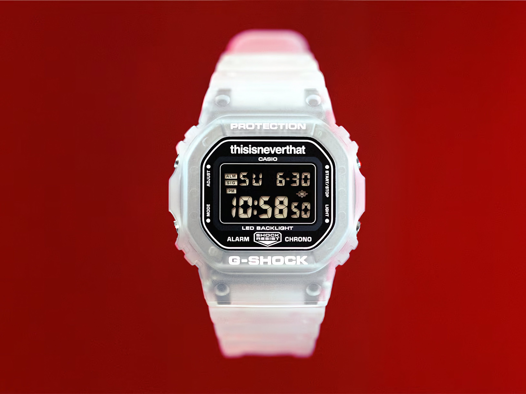 Casio G-Shock DW-5600TNT-7 x thisisneverthat với vỏ nhựa trong suốt trên nền đỏ.