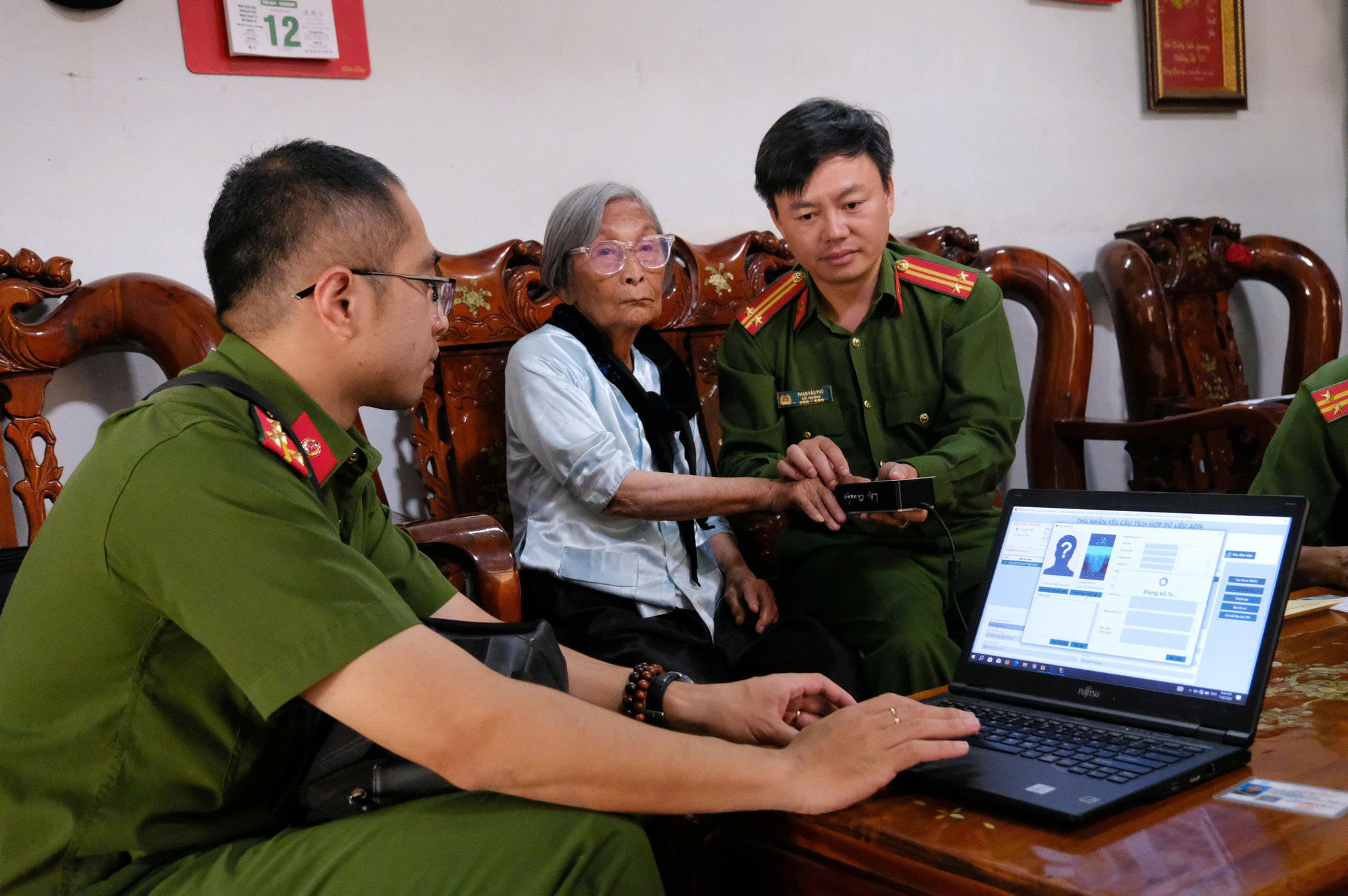 Mẹ liệt sĩ lớn tuổi nên bước lấy dấu vân tay, lớp da nhăn nheo khiến máy liên tục báo lỗi