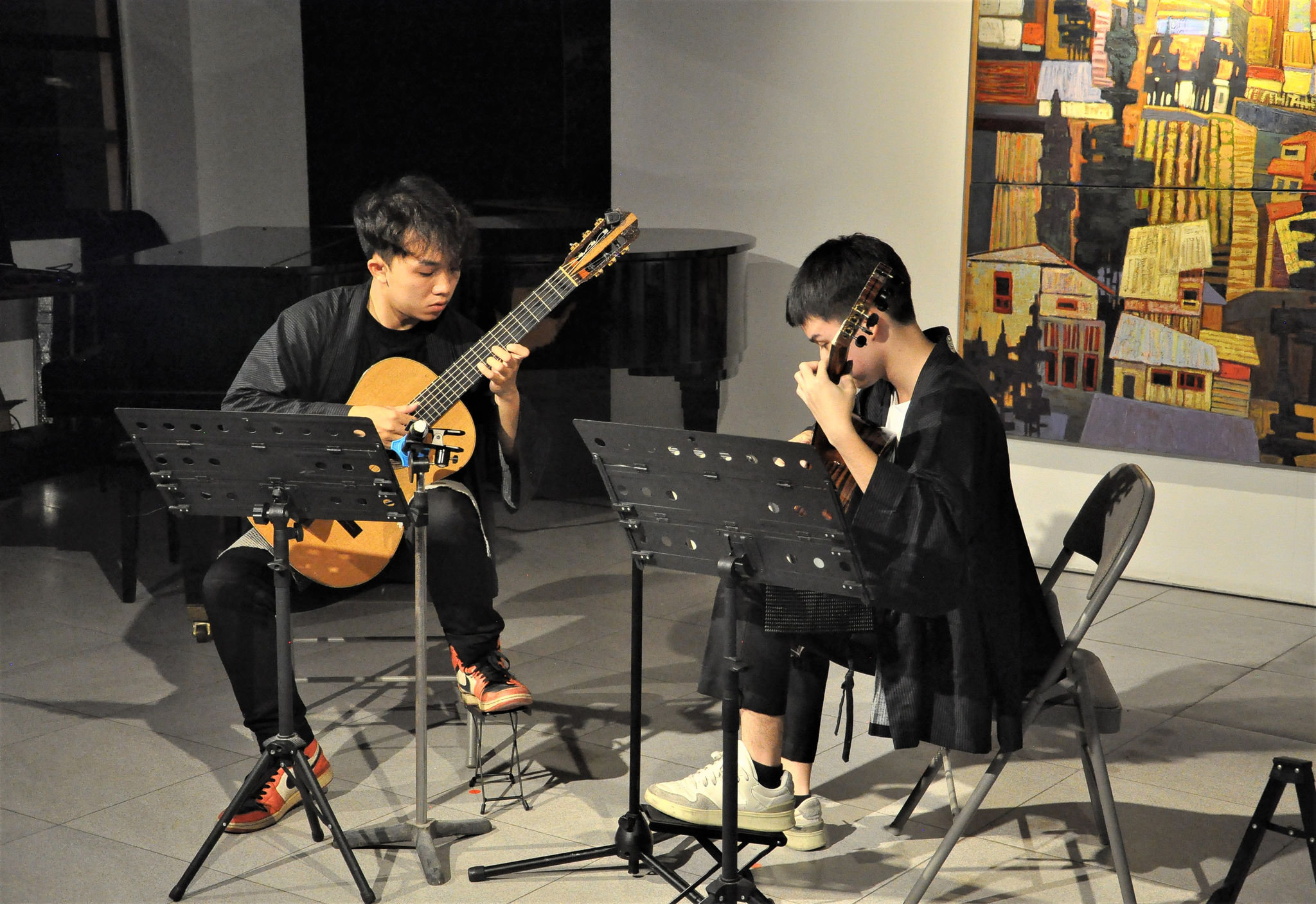 Two young Vietnamese and Thai artists perform a guitar duet