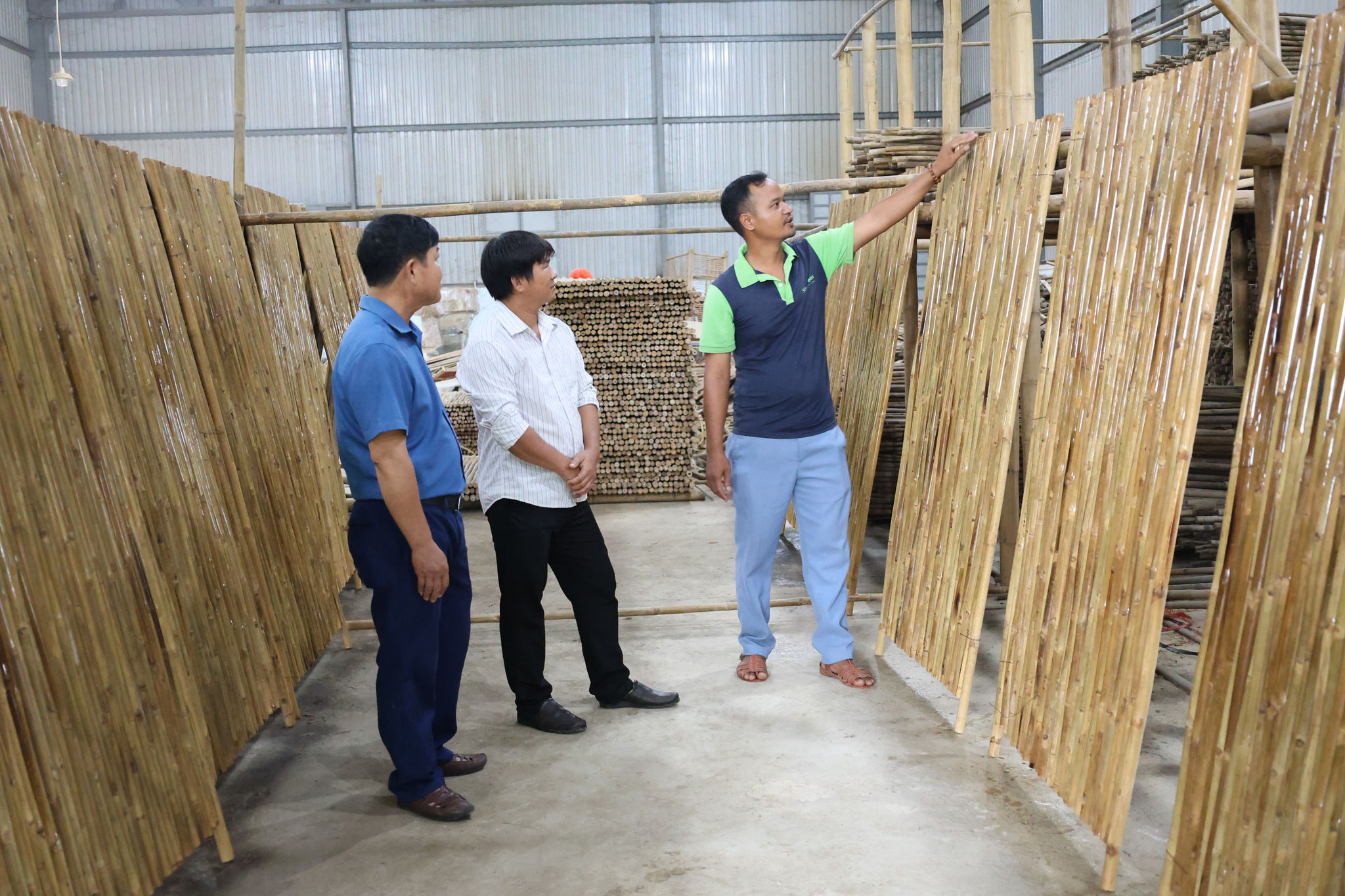 Anh K'Mưn (bên phải) giới thiệu các công đoạn tạo ra sản phẩm tại Hợp tác xã sơ chế tre tầm vông Tố Lan