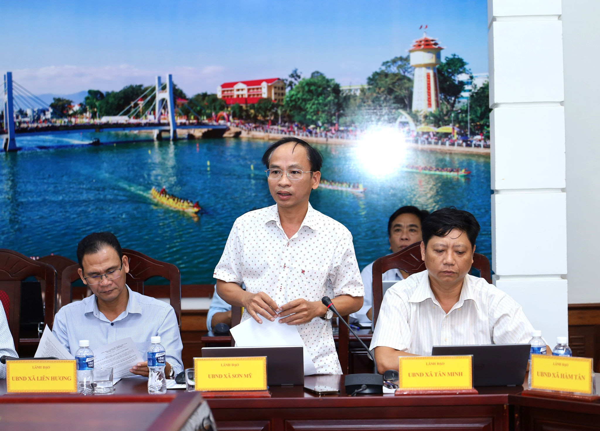 Son My Commune Chairman Nguyen Van Ty speaks at the meeting