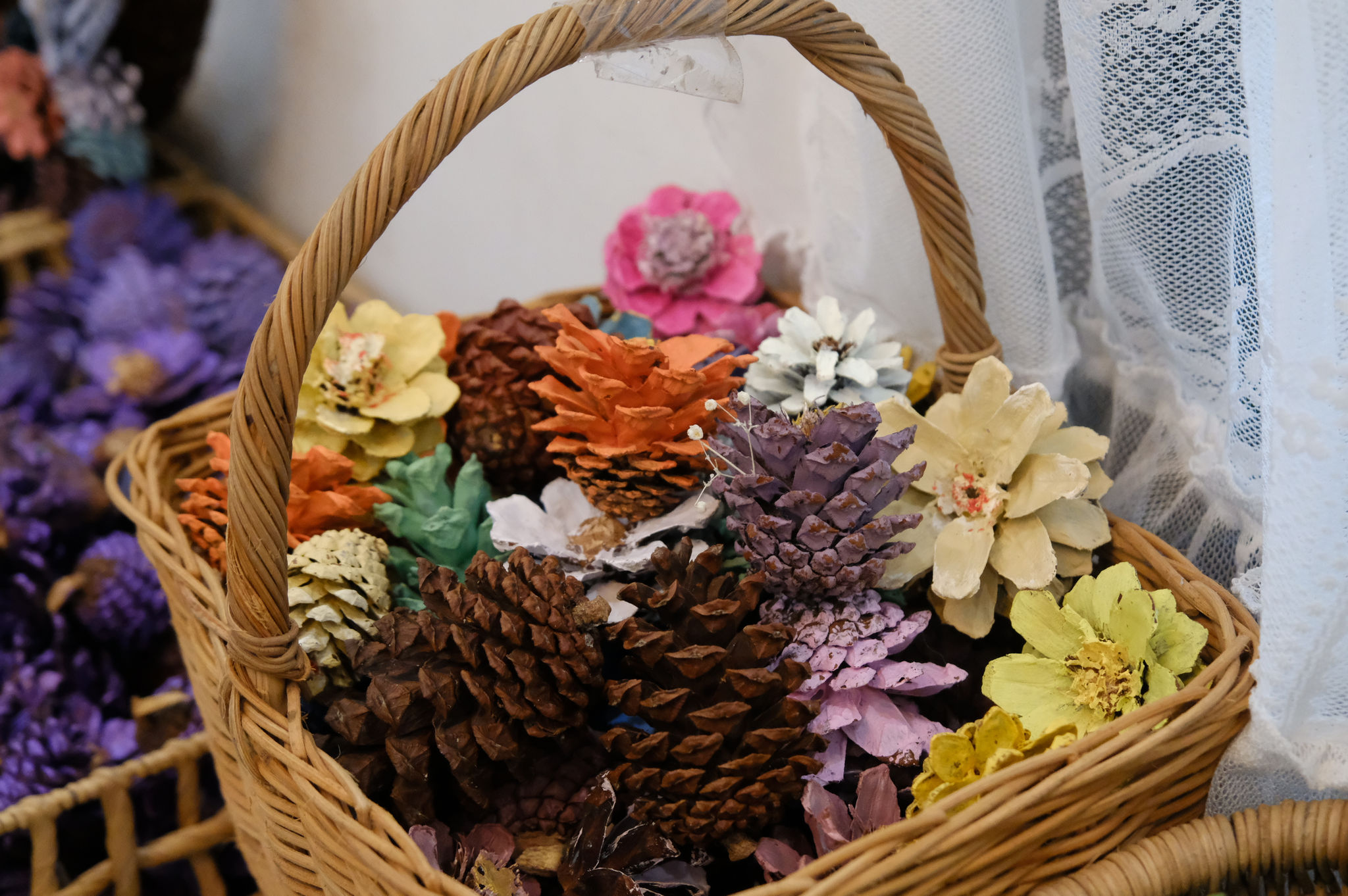 Dried pine cones are processed and painted